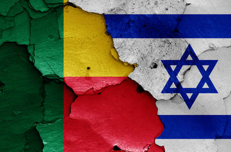 flags of Benin and Israel painted on cracked wallの写真素材