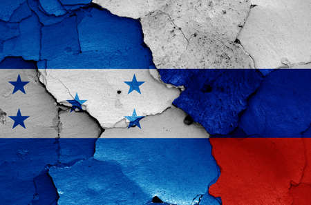 flags of Honduras and Russia painted on cracked wallの写真素材