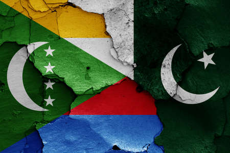 flags of Comoros and Pakistan painted on cracked wallの写真素材