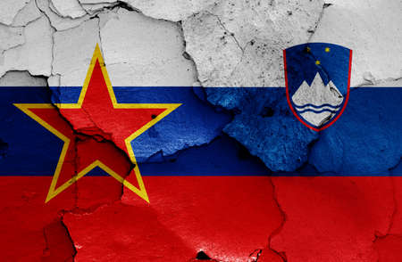 historical flag of Socialist Republic of Slovenia and today Slovenia flag on cracked wallの写真素材