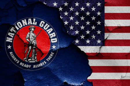 flags of United States National Guard and USA painted on cracked wallの写真素材