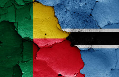 Flags of Benin and Botswana painted on cracked wallの写真素材