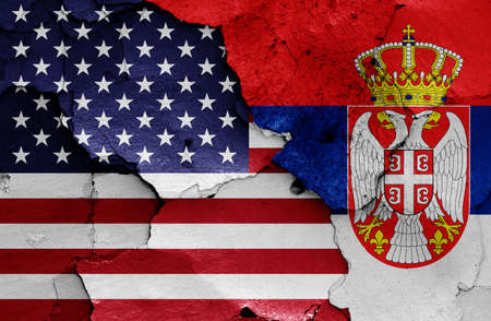 Flags of USA and Serbia painted on cracked wallの写真素材