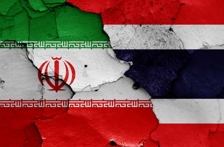 flags of Iran and Thailand painted on cracked wallの写真素材