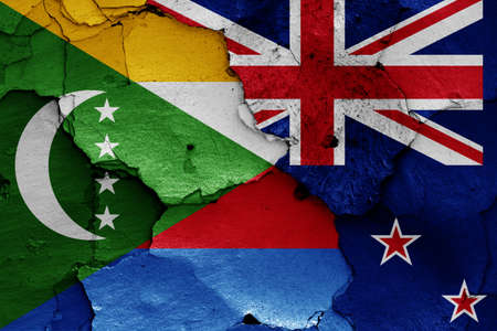 flags of Comoros and New Zealand painted on cracked wallの写真素材