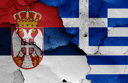 flags of Serbia and Greece painted on cracked wallの写真素材