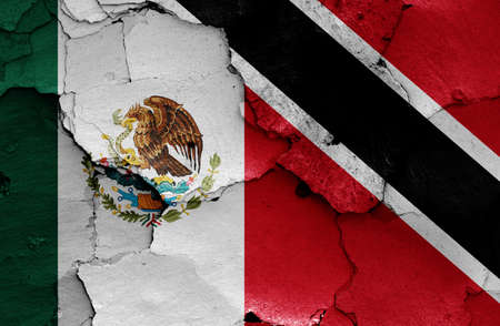 flags of Mexico and Trinidad and Tobago painted on cracked wallの写真素材
