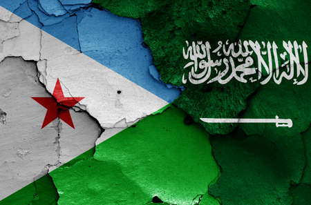 flags of Djibouti and Saudi Arabia painted on cracked wallの写真素材