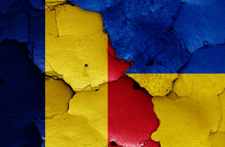 flags of Romania and Ukraine painted on cracked wallの写真素材
