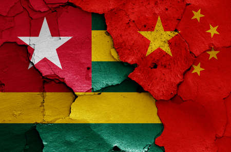 flags of Togo and China painted on cracked wallの写真素材