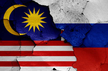 flags of Malaysia and Russia painted on cracked wallの写真素材