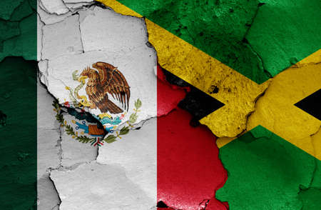 flags of Mexico and Jamaica painted on cracked wallの写真素材