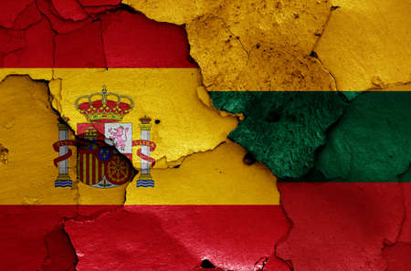 flags of Spain and Lithuania painted on cracked wallの写真素材