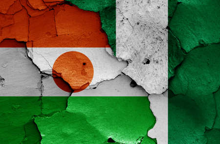 flags of Niger and Nigeria painted on cracked wallの写真素材