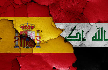 flags of Spain and Iraq painted on cracked wallの写真素材