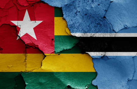 flags of Togo and Botswana painted on cracked wallの写真素材
