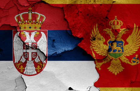 flags of Serbia and Montenegro painted on cracked wallの写真素材
