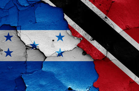 flags of Honduras and Trinidad and Tobago painted on cracked wallの写真素材