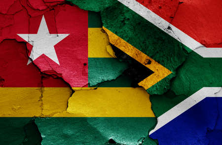 flags of Togo and South Africa painted on cracked wallの写真素材