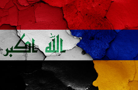 flags of Iraq and Armenia painted on cracked wallの写真素材