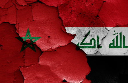 flags of Morocco and Iraq painted on cracked wallの写真素材