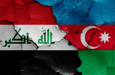 flags of Iraq and Azerbaijan painted on cracked wallの写真素材
