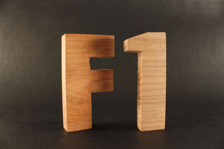 F1 text from wood letters Holz Buchstaben black Background
