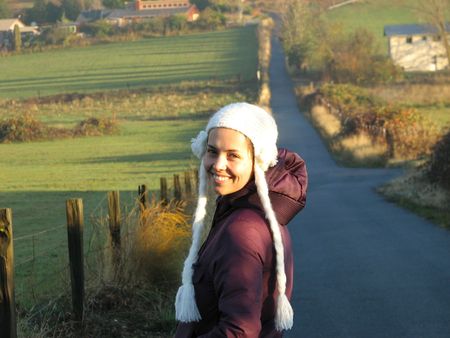 a young woman taking a walk on a country road.の写真素材