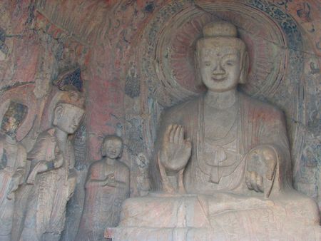 Rock cut statue depicting Buddha granting wishes and protecting against fear. This grotto still contains the original paint for the wei dynasty. Taken in Longmen, China.の写真素材
