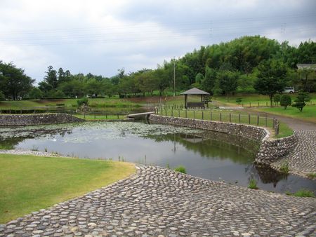A green park with pond tucked in to the hills of Kakamigahara outside of Gifu Japan.の写真素材