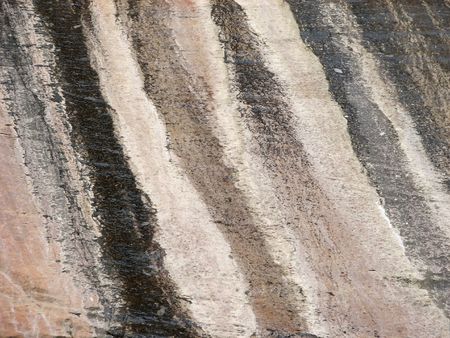 Layers of sand compressed in to smooth stone on a cliff face in Zion National Park.  Utah, U.S.A.の写真素材