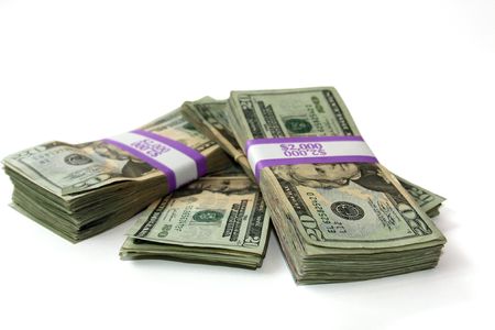 Stacks of twenty dollar bills in two thousand dollar straps isolated over white.