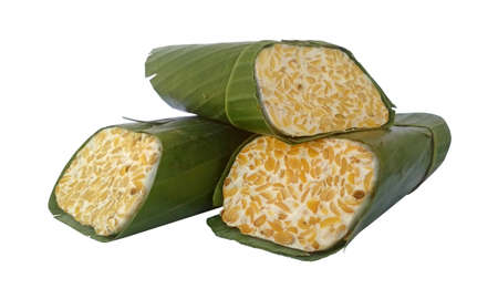 Tempe soybeans fermented wrapped with banana leaf on white