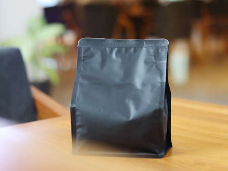 Photo of standing pouch coffee packaging on the cafe table. suitable for mock up label stickers, coffee variant packaging stickers or etc.の写真素材