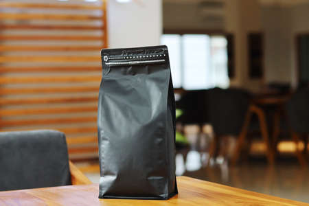 Photo of coffee packaging standing pouch size 1 Kg on the cafe table. suitable for mock-up label stickers, coffee variant packaging stickers or etc.の写真素材