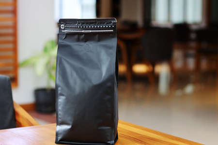 Photo of coffee packaging standing pouch size 1 Kg on the cafe table. suitable for mock-up label stickers, coffee variant packaging stickers or etc.の写真素材