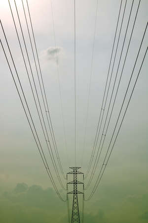 Low angle of power pylon with long transmission cableの写真素材