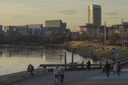 Parque fluvial en el ro Ebro, Zaragoza, Spain - February 2, 2020: Several people walk, and relax enjoying free time in the Expo river park next to the Ebro river in Zaragoza.のeditorial素材