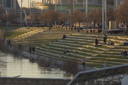 Parque fluvial en el ro Ebro, Zaragoza, Spain - February 2, 2020: Several people walk, and relax enjoying free time in the Expo river park next to the Ebro river in Zaragoza.のeditorial素材