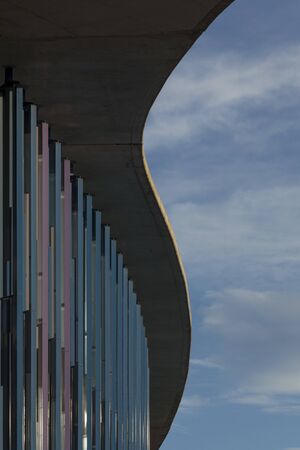 Abstract vertical lines and curved concrete structure roof of design buildings with design...