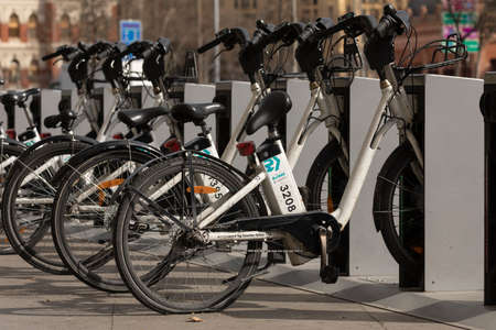 Madrid, Spain - February 25, 2020: Dirty and broken electric bicycles from the public urban transport service BiciMAD from the EMT public company, parked in front of Atocha train station in Madridのeditorial素材