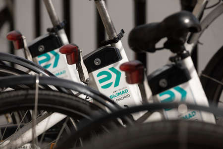Madrid, Spain - February 25, 2020: Dirty and broken electric bicycles from the public urban transport service BiciMAD from the EMT public company, parked in front of Atocha train station in Madridのeditorial素材