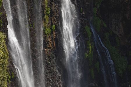 Close-up of the fresh and intense falling water in Tumpak Sewu Waterfall, in East Java, Indonesia.の写真素材