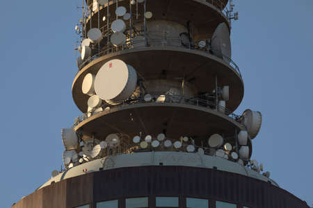 Madrid, Spain - May 19, 2020: Close-up detail of the Torrespa? ? a digital television and radio tower at sunset, with its swarm of satellite dishes.のeditorial素材