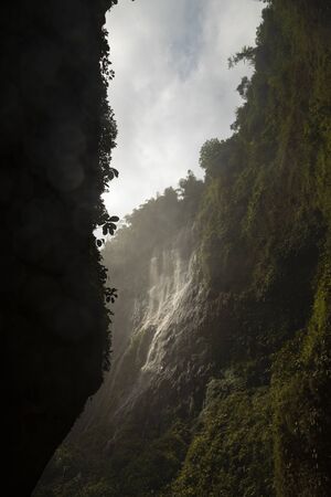 View of the fresh, noisy and intense water in Tumpak Sewu Waterfall, in East Java, Indonesia.