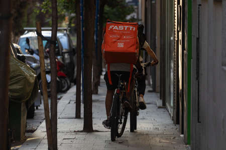 Madrid, Spain - May 19, 2020: Delivery people from the home delivery company, fasttiapp, working on...