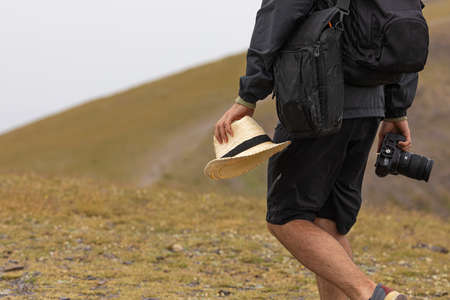 A young man enjoys taking photos in nature on his way to the cold summit of Moncayo, the highest...