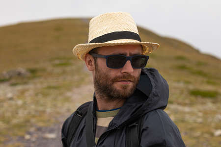 A young man enjoys a walk in the middle of nature, towards the cold summit of Moncayo, the highest...