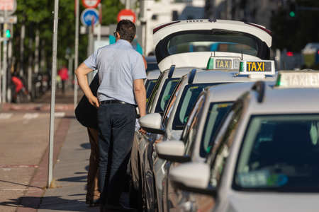 Madrid, Spain - May 19, 2020: Taxis of the private public taxi service of the city of Madrid, in service, on O'Donnell street, in the central district of Retiro.のeditorial素材