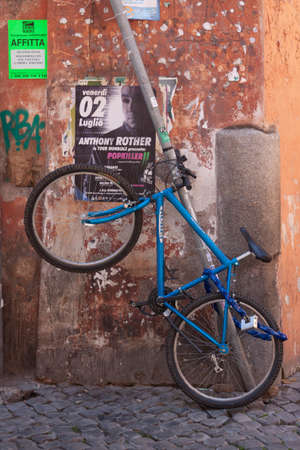 Rome, Italy - June 28, 2010: A blue mountain bike, hanging in a corner of one of the central streets of Rome.のeditorial素材